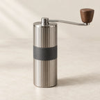 Ribbed steel manual coffee grinder with walnut handle
