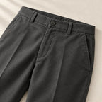 Waistband, button and pocket details of the charcoal trousers
